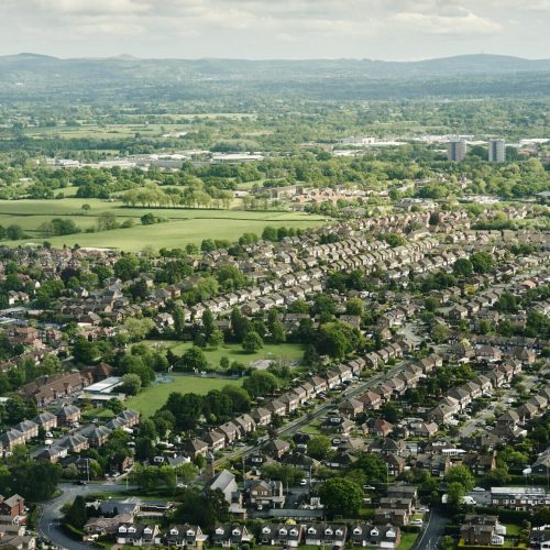 Aerial view of suburban housing and distant landscape, England, UK
