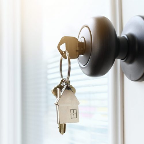 key-ring-with-a-house-on-it-inserted-in-a-front-do-2023-11-27-05-24-31-utc